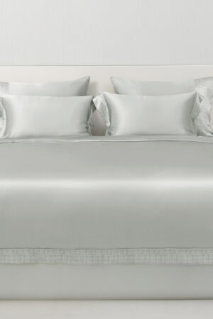 Aether silk bedding in quartz gray silk, neatly arranged bed view highlighting the smooth texture and refined style.