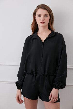 Woman wearing black Athflow women's sun protection hoodie set, front view.