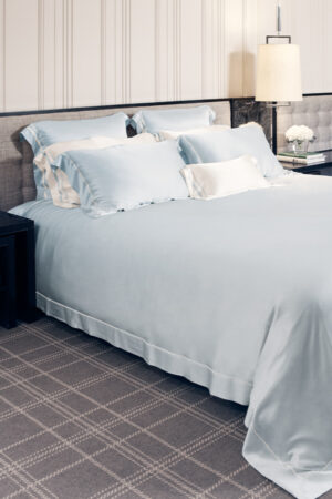 MANITO Authentic Silk Duvet Cover in baby blue color showcased on a bed with matching pillowcases.