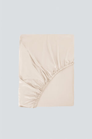 Folded MANITO Authentic Silk Fitted Sheet in champagne beige with visible elastic band and glossy finish.