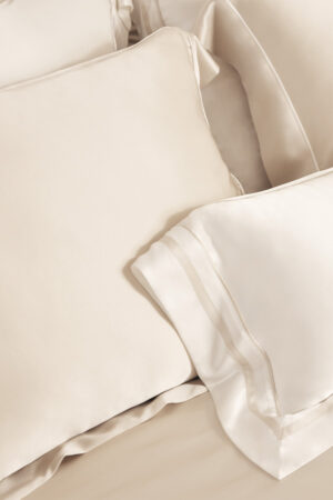 MANITO Authentic Silk Pillowcase Set in cream and ivory, layered to show soft sheen and luxurious texture.