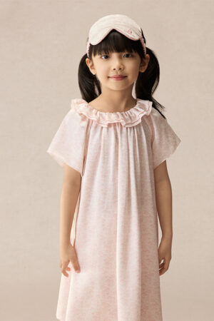Girl wearing BONPOINT×MANITO Celestial Kid's Nightdress Gift Box in soft pink silk with matching eye mask and ruffled neckline.
