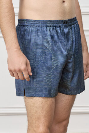 Side view of model in Cube Men's Shorts, highlighting the tailored cut and subtle geometric texture on soft silk fabric.