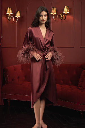 Red holiday long robe with luxurious silk and feather cuffs, designed for festive celebrations.