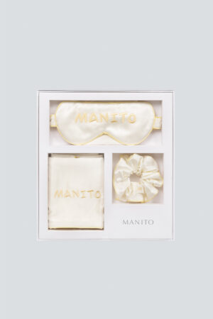 Luxury creamy white MANITO macaron silk eye mask gift box set displayed with eye mask, scrunchie, and pillowcase.