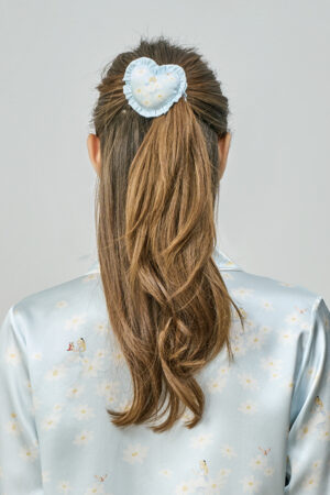 Back view of model with ponytail styled using blue MANITO DISNEY Alice Daisy Heart Hair Scrunchy, showing a soft and playful look.