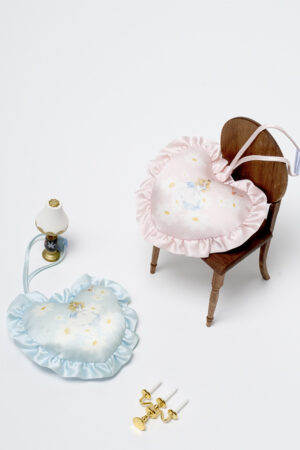 MANITO Alice Daisy Sachets in pink and blue, heart-shaped silk with ruffled trim, styled with mini chair and lamp for a whimsical display.