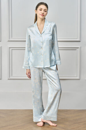 Woman in blue MANITO DISNEY Daisy Pajama Set standing barefoot with relaxed pose in front view.