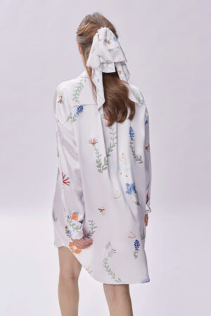 Woman wears Alice Fantasy Forest Bow Hair Band with long ribbons cascading down her ponytail, showcasing an elegant back view.