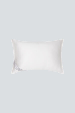 Premium silk filled pillow with 'MANITO' tag, offering a soft and luxurious addition to bedroom comfort.
