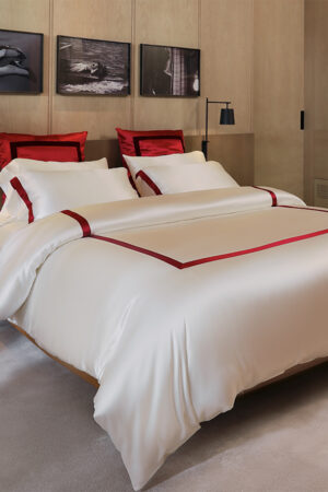 Classic MANITO French bedding set with white silk duvet cover and bold red trim, adding a touch of luxury to the bedroom decor.