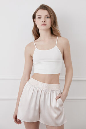 Model wearing Passion Women's Silk Shorts in ivory with elastic waistband and side pocket.