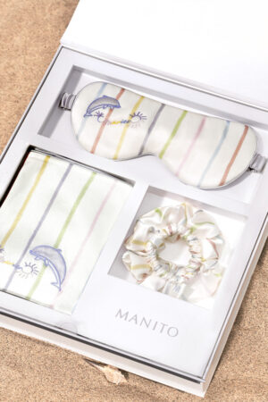 MANITO Ocean Stripe Sleeping Beauty Gift Box featuring a silk eye mask, pillowcase, and scrunchies with a vibrant stripe pattern.