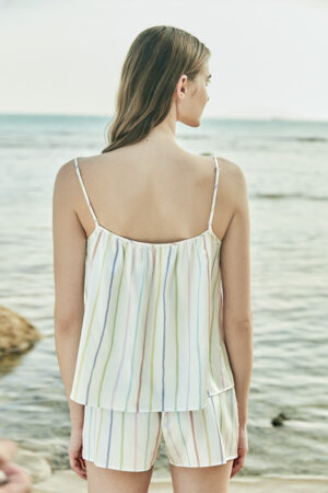 Model displaying the back design of MANITO rainbow striped tank top and shorts, offering a relaxed and airy look.