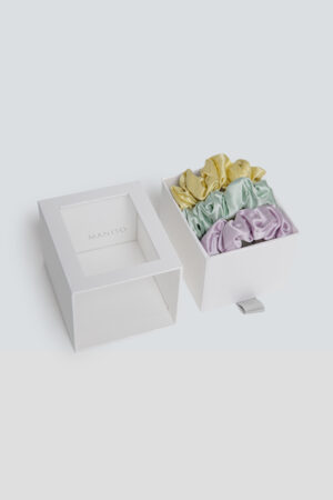 3 Pack Large Silk Scrunchie Set in pastel yellow, mint green, and lilac, bringing a fresh, playful touch to everyday styling.