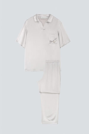 Flat lay of the ivory MANITO Remington Men's Short Sleeve Pajama Set, featuring a relaxed-cut shirt and matching pants.