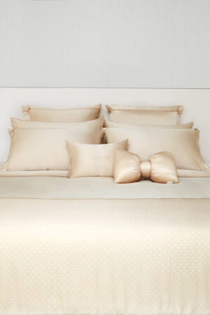 Luxurious MANITO polka dot duvet cover set displayed on a neatly arranged bed.
