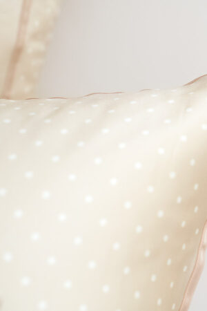 Detailed view of polka dot silk fabric, highlighting the premium quality and softness of the MANITO Ribbon Silk Pillowcase.