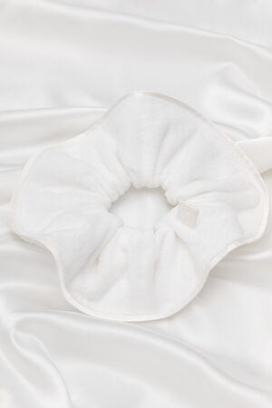 MANITO Silk Terry Scrunchie displayed on a smooth white surface, showcasing product view.