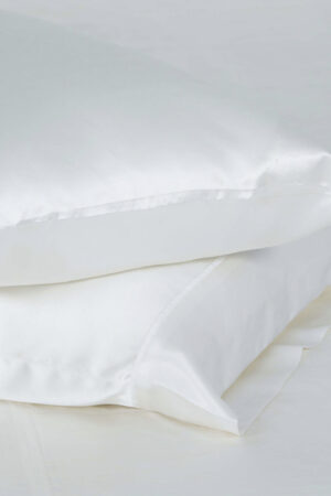 Elegant white silk pillowcases set from The 22 Collection, showcasing smooth texture.