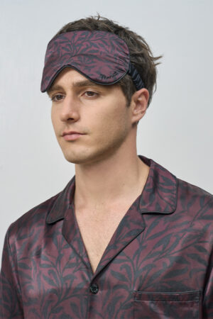 Side view of model in Tropical Leaves Men's Eye Mask, showing smooth silk texture that enhances restful comfort.