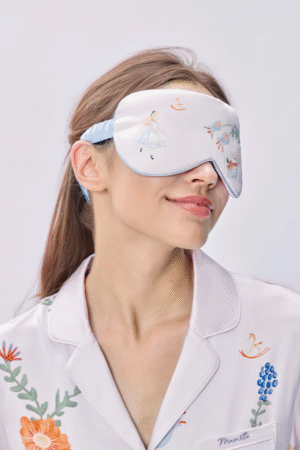 Woman wears eye mask from Forest Sleeping Beauty Gift Box, soft contour resting lightly over her eyes for a calm nap.